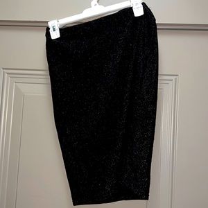Fitted black sparkle Amazon skirt.